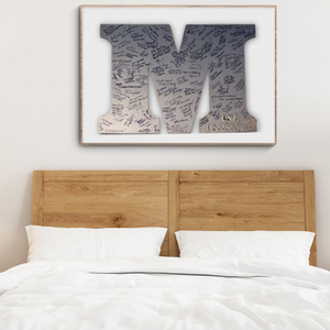 Bedroom with wooden headboard, white bedding, and framed artwork on the wall.