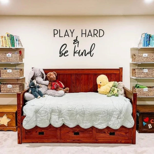 Children's bedroom with wooden bed, toys, and shelves with books and baskets.